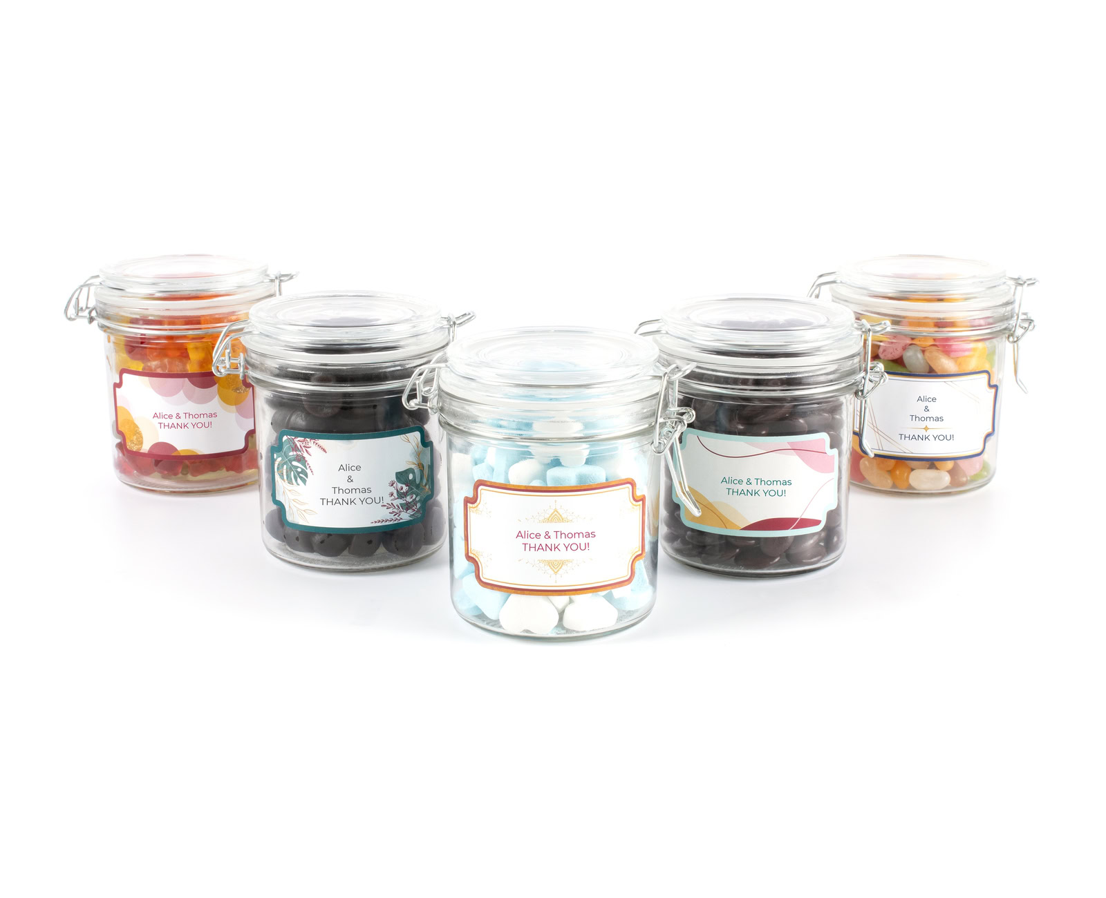 five medium wedding thank you candy jars with personalised labels in different designs and with different fillings
