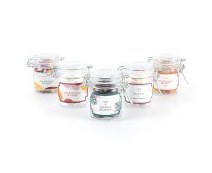 five small Valentine's Day thank you candy jars with personalised labels in different designs and with different fillings.
