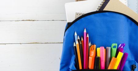 Blue schoolback with pencils and paper