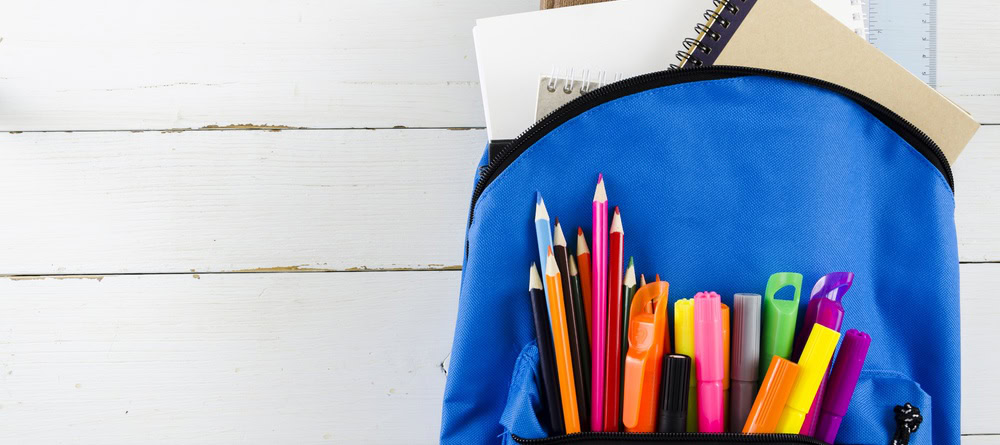 Blue schoolback with pencils and paper