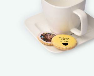Printed licorice biscuits with text and photo presented on a platter