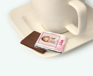 Mini chocolates with photo presented on a saucer as a communion thank-you gift
